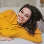 girl-woman-teeth-smile-sofa