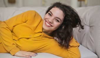 girl-woman-teeth-smile-sofa