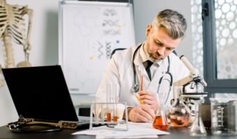 senior-man-research-scientist-writes-notes-lab