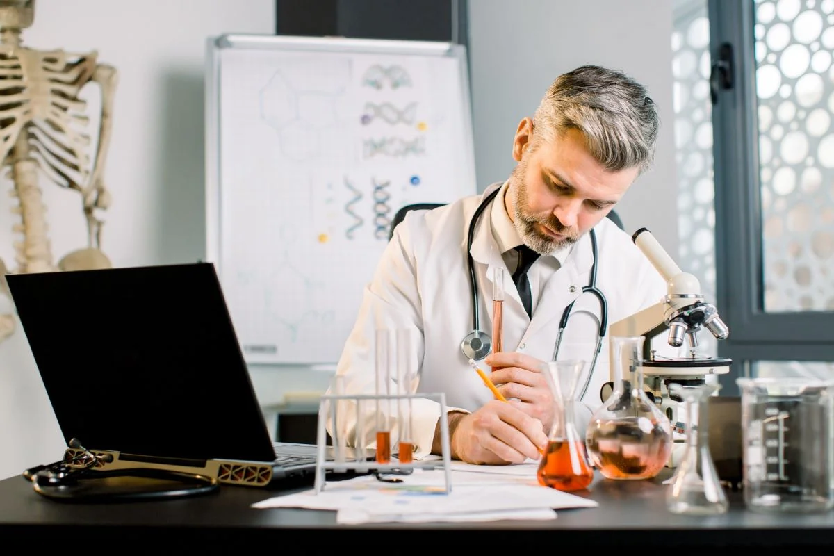 senior-man-research-scientist-writes-notes-lab