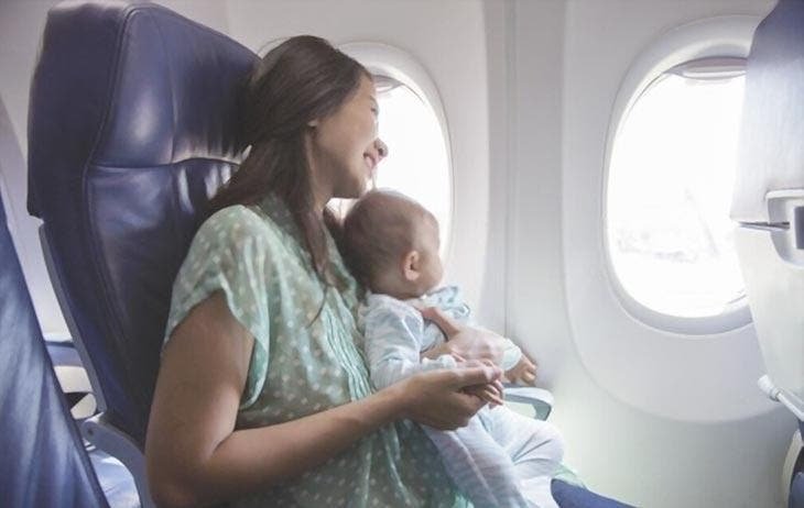 A woman sitting with her baby on the plane