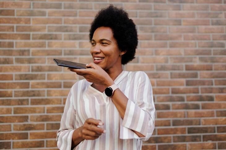 Woman recording an audio message on her mobile phone