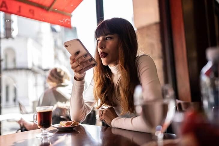 Woman recording an audio message on her smartphone