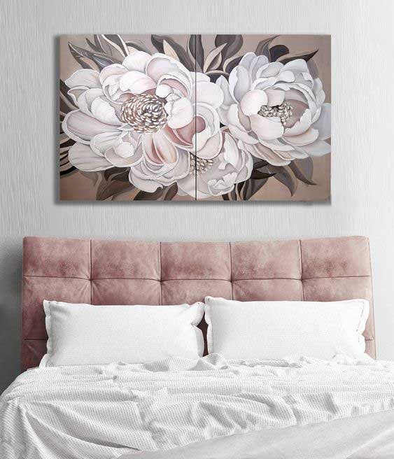 A floral painting hanging above the bed